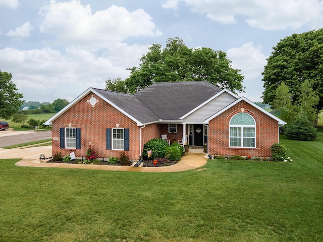 725 Loxley Ln, Troy, OH 45373 - ranch-style house featuring brick siding, a front lawn, and roof with shingles