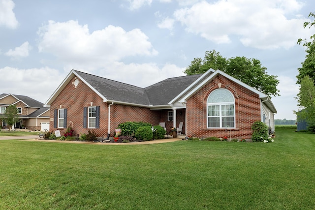 725 Loxley Ln, Troy, OH 45373 - single story home with brick siding, a front yard, and roof with shingles