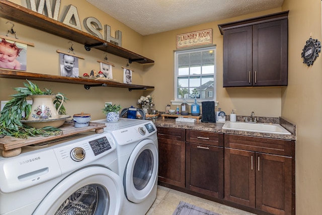 725 Loxley Ln, Troy, OH 45373 - laundry room featuring separate washer and dryer, cabinet space, light tile patterned floors, and a textured ceiling