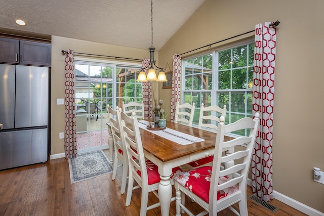 725 Loxley Ln, Troy, OH 45373 - dining room with wood finished floors, vaulted ceiling, plenty of natural light, baseboards, and a textured ceiling