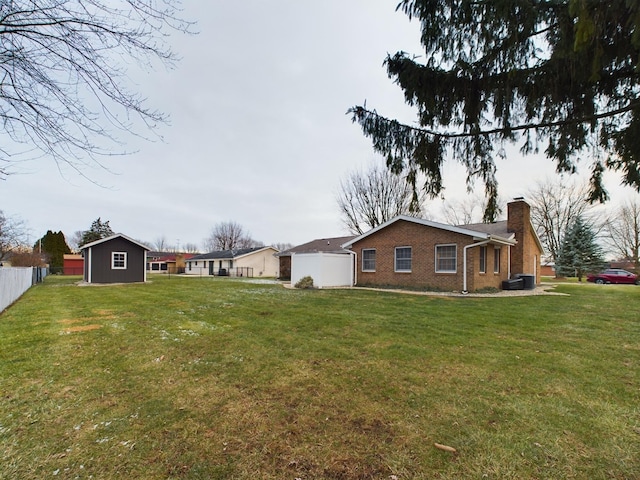 view of yard with a storage unit and central AC unit