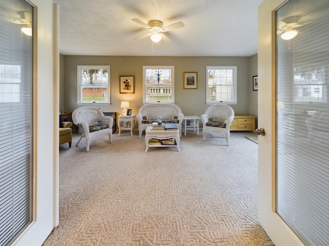 living room featuring ceiling fan and carpet