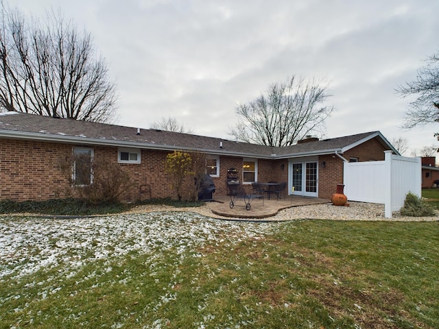 rear view of property with a patio and a yard