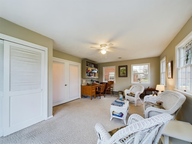 carpeted living room featuring ceiling fan and a healthy amount of sunlight