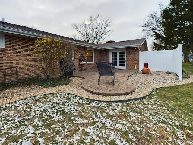 rear view of property featuring a patio area and french doors