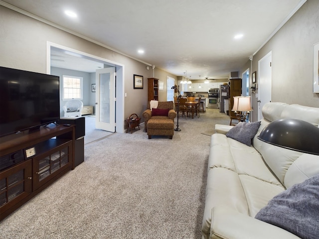 carpeted living room featuring ornamental molding