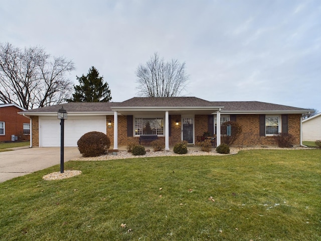 single story home with a garage and a front lawn