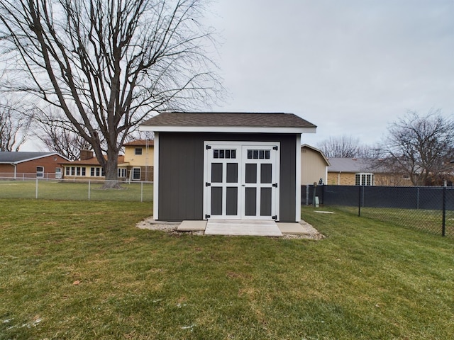 view of outbuilding with a yard