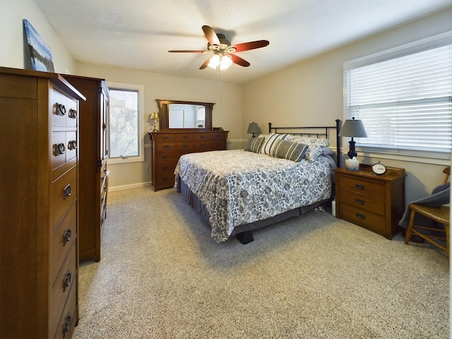 bedroom featuring light colored carpet and ceiling fan