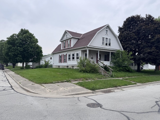 724 W S St, Saint Marys, OH 45885 - dutch colonial with covered porch, a front lawn, a shingled roof, and a gambrel roof
