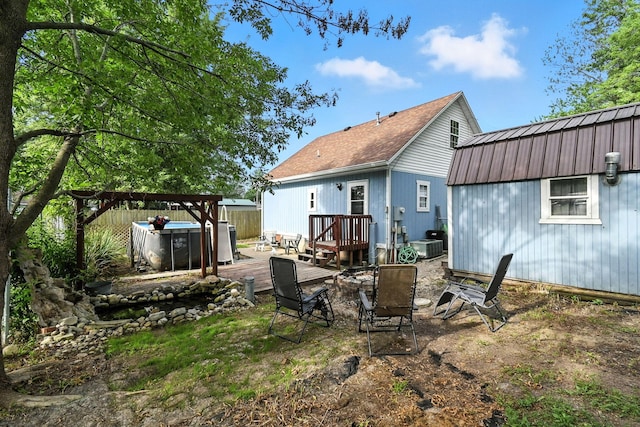 11372 Kickapoo Path, Lakeview, OH 43331 - back of house featuring a metal roof, a gambrel roof, a hot tub, and a wooden deck