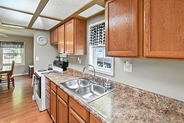 11372 Kickapoo Path, Lakeview, OH 43331 - kitchen with electric stove, brown cabinets, and light wood-type flooring