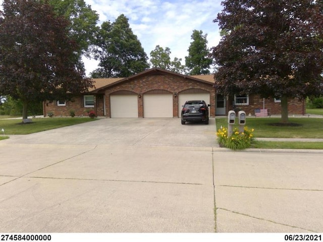 view of front of house with a garage and a front yard