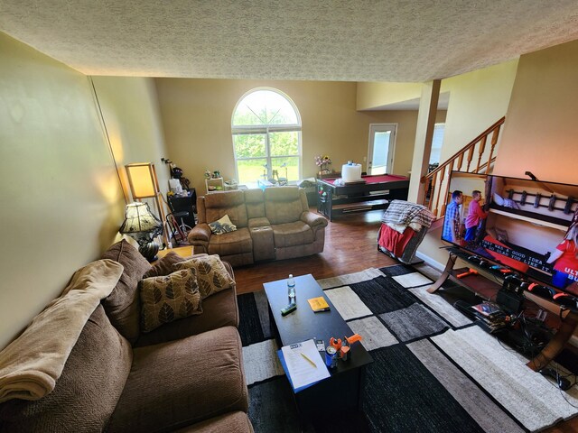 2380 W Patterson Ln, Troy, OH 45373 - living room with a textured ceiling, stairway, and wood finished floors