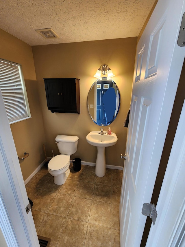 2380 W Patterson Ln, Troy, OH 45373 - half bathroom featuring a textured ceiling and tile patterned flooring