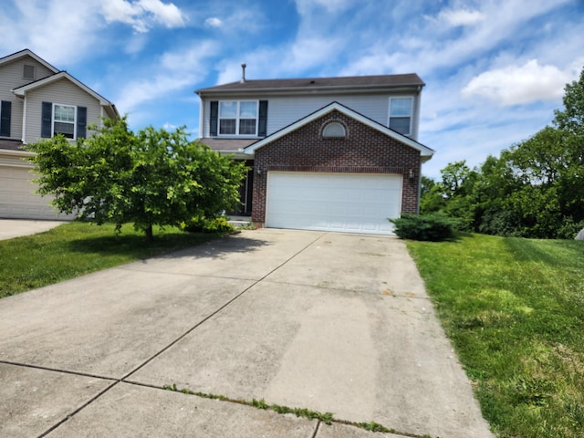 2380 W Patterson Ln, Troy, OH 45373 - traditional home featuring brick siding, driveway, a front yard, and a garage