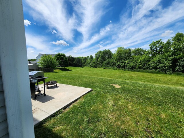 2380 W Patterson Ln, Troy, OH 45373 - view of green lawn featuring a patio area and an outdoor fire pit