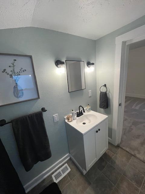 904 W High St, Piqua, OH 45356 - bathroom featuring a textured ceiling and vanity