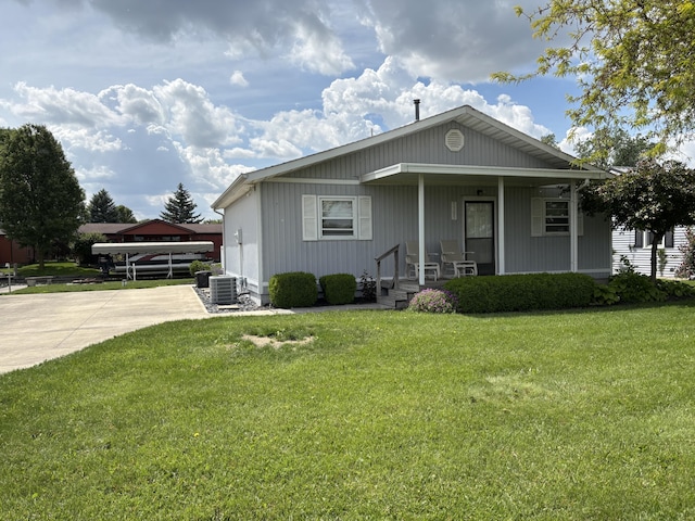 5305 Karafit Rd, Celina, OH 45822 - bungalow-style house with covered porch, a front yard, and central air condition unit