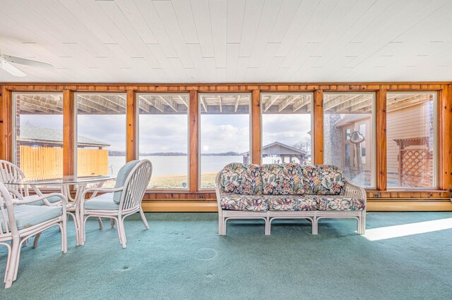 10989 Seminole Shore Dr, Huntsville, OH 43324 - sunroom / solarium with a baseboard radiator, carpet flooring, and a water view