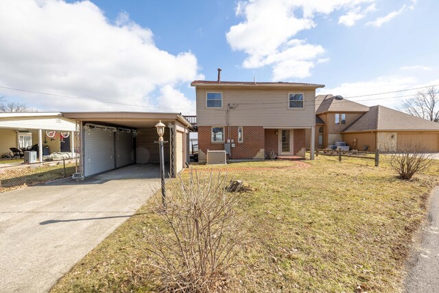 10989 Seminole Shore Dr, Huntsville, OH 43324 - view of front of house featuring concrete driveway, brick siding, a front yard, and cooling unit