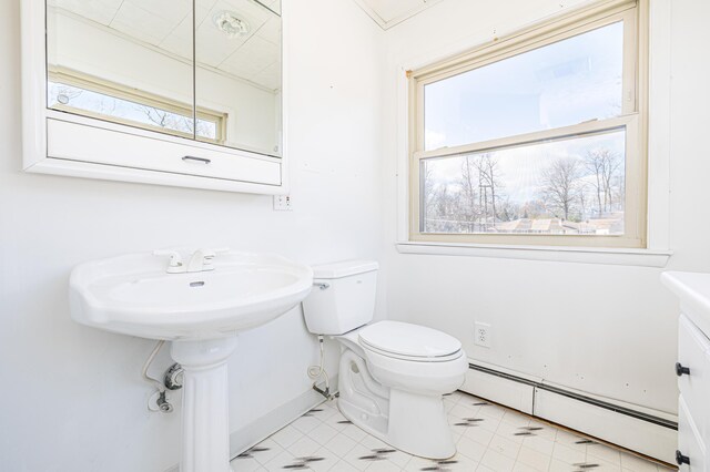 10989 Seminole Shore Dr, Huntsville, OH 43324 - half bathroom featuring baseboard heating, toilet, and baseboards