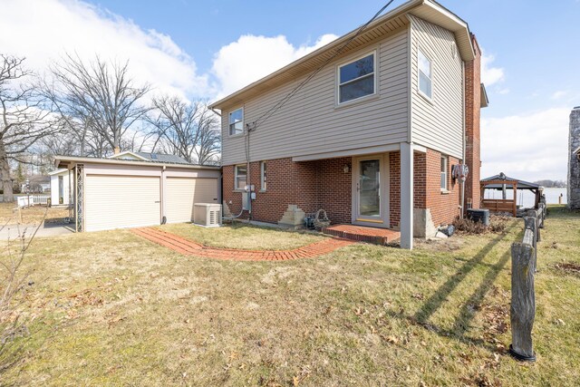 10989 Seminole Shore Dr, Huntsville, OH 43324 - back of house with brick siding, a yard, and a gazebo