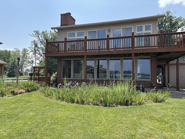 10989 Seminole Shore Dr, Huntsville, OH 43324 - back of property featuring a deck, a chimney, a lawn, and brick siding