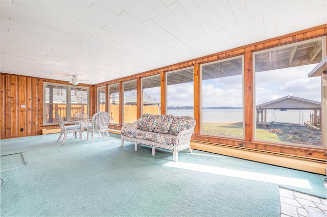 10989 Seminole Shore Dr, Huntsville, OH 43324 - sunroom / solarium featuring a water view, carpet flooring, wooden walls, a baseboard heating unit, and a ceiling fan