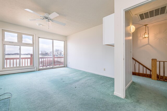 10989 Seminole Shore Dr, Huntsville, OH 43324 - empty room with carpet flooring, baseboards, a ceiling fan, and a baseboard radiator