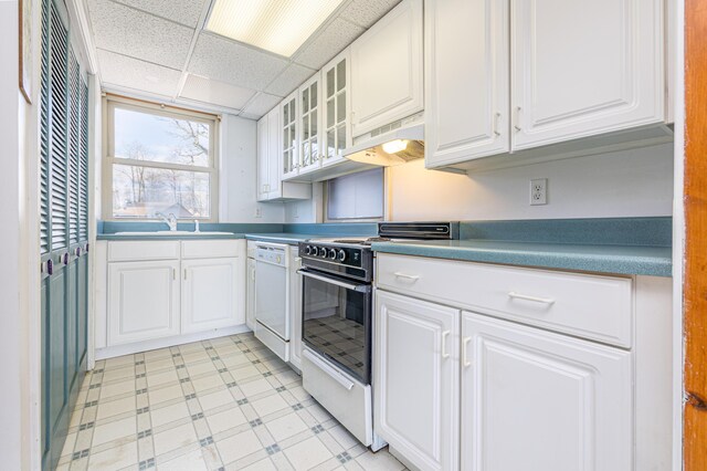 10989 Seminole Shore Dr, Huntsville, OH 43324 - kitchen featuring range, dishwasher, under cabinet range hood, light floors, and white cabinets