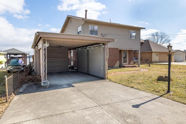 10989 Seminole Shore Dr, Huntsville, OH 43324 - traditional-style home featuring driveway and a carport