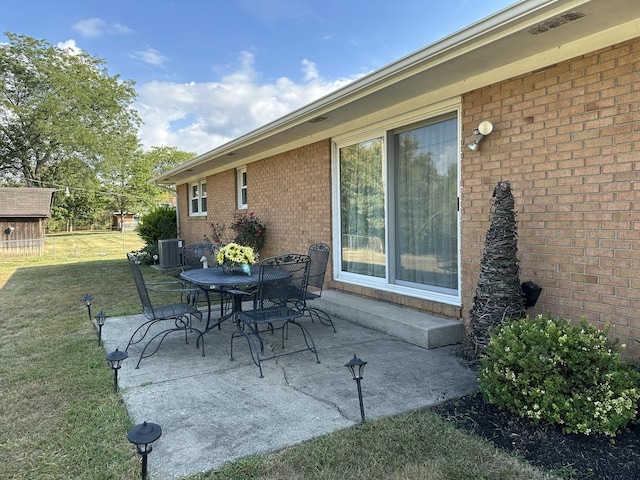 view of patio / terrace with outdoor dining space and central air condition unit