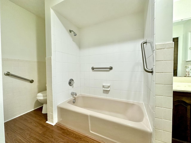 full bathroom featuring a wainscoted wall, tile walls, toilet, vanity, and wood finished floors