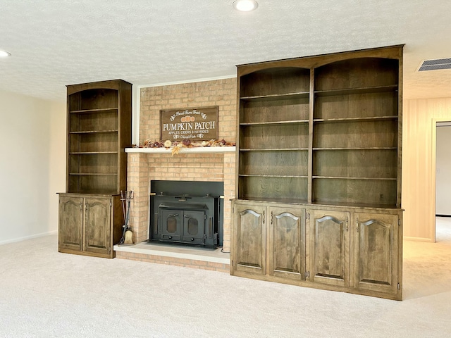 unfurnished living room featuring carpet, visible vents, a textured ceiling, and recessed lighting