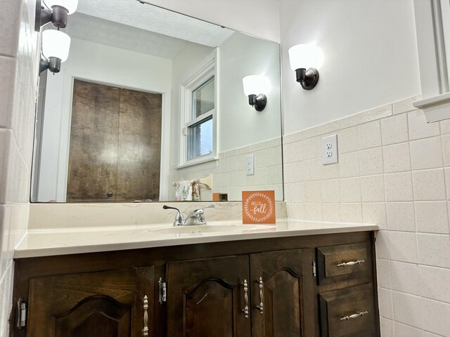 bathroom with tile walls and vanity