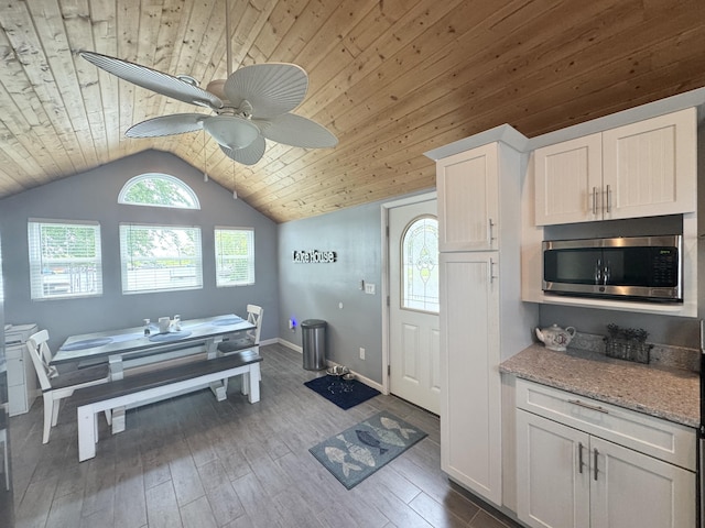 13864 Public Dr, Lakeview, OH 43331 - kitchen with stainless steel microwave, ceiling fan, wooden ceiling, dark wood-style floors, and lofted ceiling
