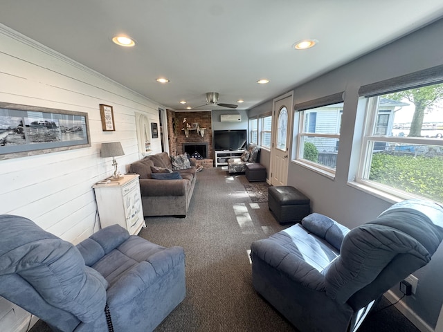 13864 Public Dr, Lakeview, OH 43331 - living area with wood walls, recessed lighting, a brick fireplace, ceiling fan, and carpet