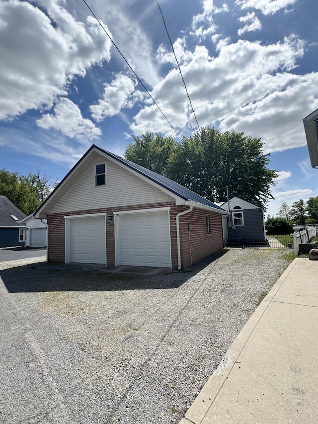 13864 Public Dr, Lakeview, OH 43331 - view of side of property with a garage, brick siding, and an outdoor structure