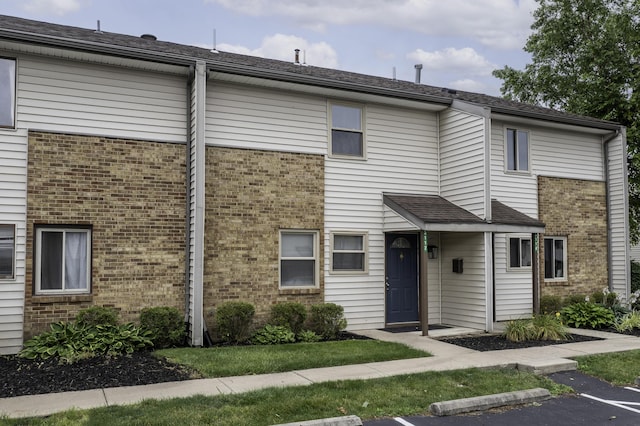 3112 Legend Way, Dayton, OH 45449 - view of front facade featuring brick siding and uncovered parking
