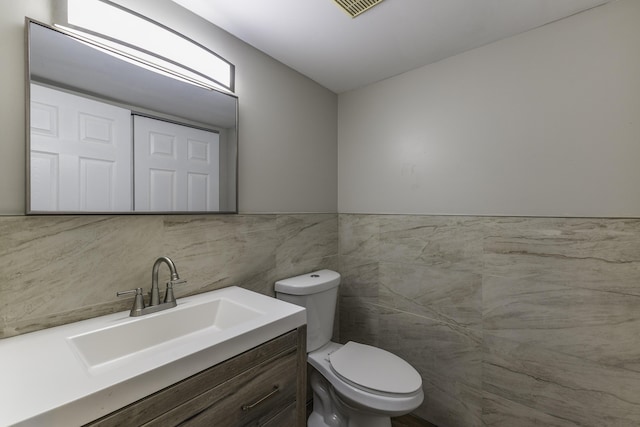 3112 Legend Way, Dayton, OH 45449 - bathroom featuring tile walls, vanity, and a wainscoted wall