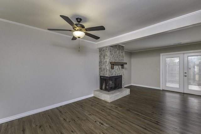 3112 Legend Way, Dayton, OH 45449 - unfurnished living room with a stone fireplace, dark wood-style flooring, ceiling fan, ornamental molding, and french doors
