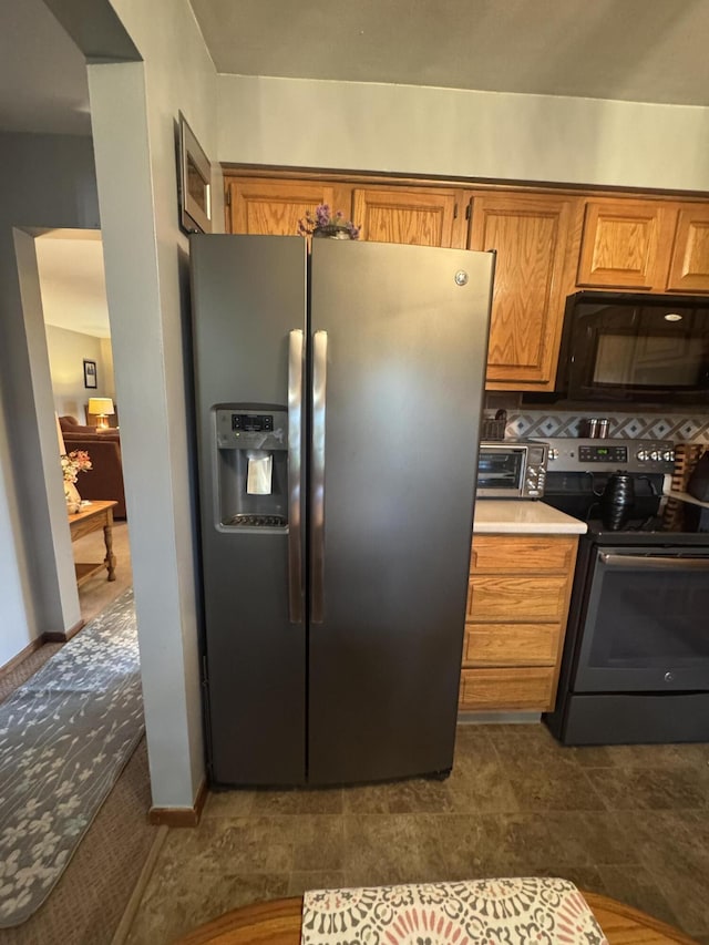 612 S Main St, Saint Marys, OH 45885 - kitchen featuring black appliances, brown cabinetry, and light countertops