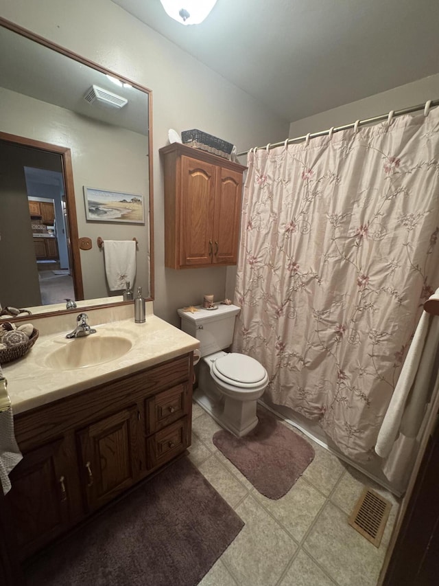 612 S Main St, Saint Marys, OH 45885 - bathroom with toilet, vanity, and tile patterned floors