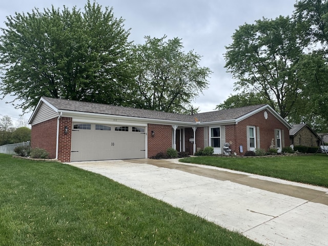 612 S Main St, Saint Marys, OH 45885 - single story home featuring brick siding, a garage, concrete driveway, and a front lawn