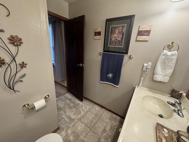 612 S Main St, Saint Marys, OH 45885 - bathroom with a sink, baseboards, and toilet