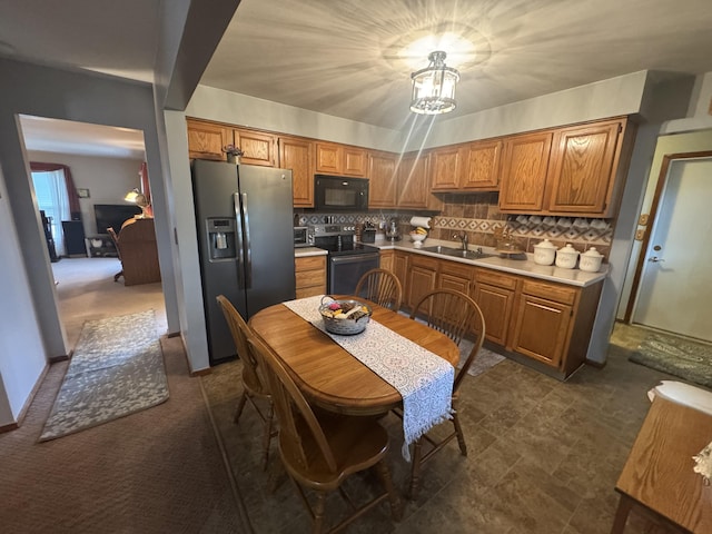 612 S Main St, Saint Marys, OH 45885 - kitchen with stainless steel fridge with ice dispenser, electric range, black microwave, a sink, and light countertops