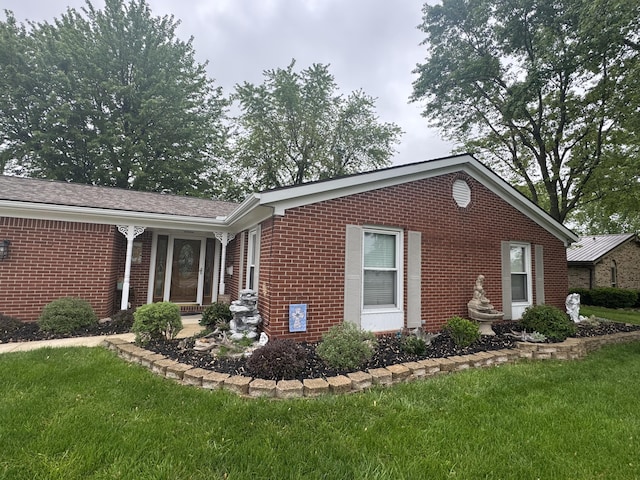 612 S Main St, Saint Marys, OH 45885 - view of side of home featuring brick siding and a lawn