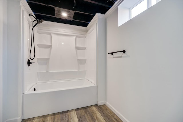 full bathroom with baseboards, wood finished floors, and shower / bathtub combination