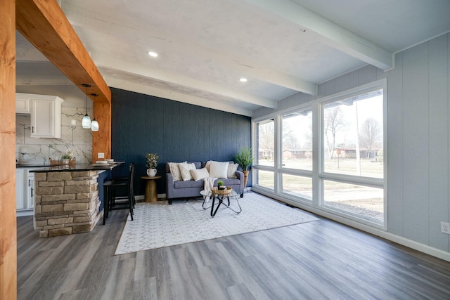 living room with beamed ceiling, recessed lighting, wood finished floors, and baseboards